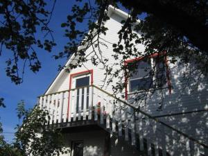 a white house with a balcony on the side of it at Liiva Guest Accommodation in Tartu