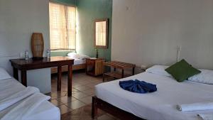 Una cama o camas en una habitación de Cayuco Maya
