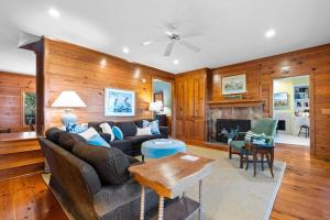 a living room with a couch and a fireplace at Windows on the Water in Pawleys Island