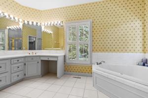 a bathroom with a tub and a sink and a bath tub at Windows on the Water in Pawleys Island +33 photos