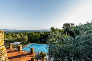 a villa with a swimming pool and trees at Tenuta Panoramica sulle Colline Toscane in Paterna
