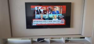 einen Flachbild-TV an der Wand in der Unterkunft Apartamento no Edifício Time Maceió in Maceió