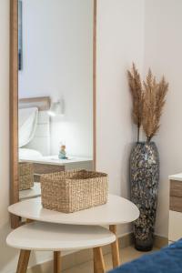 a mirror and a table with a basket on it at Apartments Ranko in Zavalatica