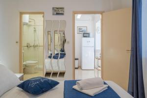 a bedroom with a bed and a bathroom with a shower at Apartments Ranko in Zavalatica