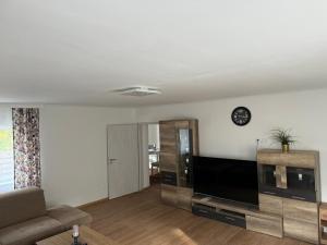 a living room with a large flat screen tv at 3-Perfekt für jeden Zweck in Marktredwitz