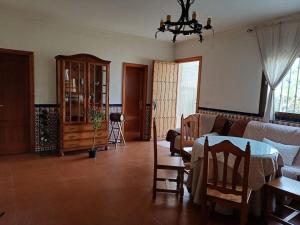 a living room with a table and a couch at Rincón Subbético in Luque +2 photos
