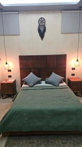 a bedroom with a large green bed with two tables at Kasa Nikte in Tulum