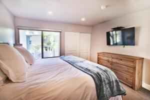 a bedroom with a bed and a tv on the wall at Ski In and Out, Canyons Village Hidden Creek, Private Hot Tub in Park City +31 photos