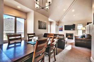 a dining room and living room with a table and chairs at Ski In and Out, Canyons Village Hidden Creek, Private Hot Tub in Park City