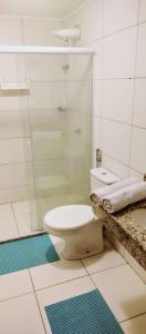 ein Badezimmer mit Toilette und Glasdusche in der Unterkunft Charmoso Apartamento na Terceira praia de Morro in Morro de São Paulo