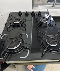 einen Herd mit vier Brennern in der Küche in der Unterkunft Bela casa 3 quartos perto do Buritis in Belo Horizonte