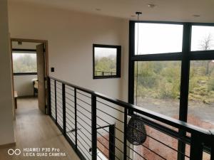 a room with a balcony with large windows at Emai in Las Trancas +8 photos