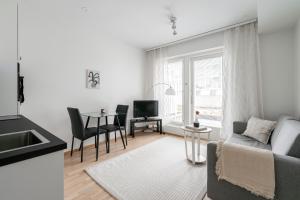 a living room with a couch and a table at Modern 1BR Apartment in Kaleva next to Tram Line in Tampere