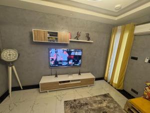 a living room with a flat screen tv on a wall at STUDIO A Mbour in Mbour