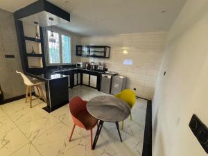 a kitchen with a table and chairs in a room at STUDIO A Mbour in Mbour