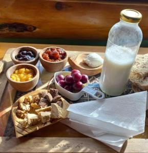 a table with a tray of food and a glass of milk at Cabañas SurEnya in El Bolsón