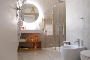a bathroom with a toilet and a sink and a mirror at Salento astrea vista mare in Porto Cesareo