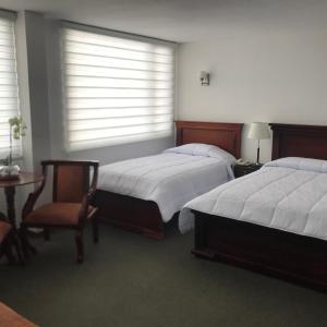 Postel nebo postele na pokoji v ubytování Altura Rooms & Suites