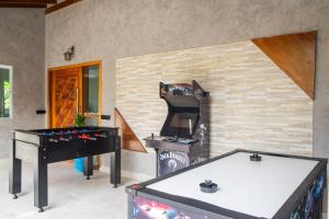 a living room with a piano and a fireplace at Casa com piscina aquecida, Condomínio a beira mar in Bertioga