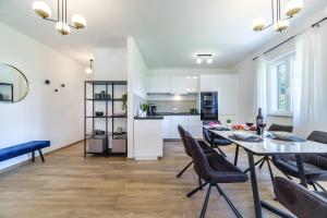 a kitchen and dining room with a table and chairs at House Villa Gold in Splitska