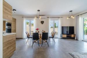 a kitchen and dining room with a table and chairs at House Villa Gold in Splitska