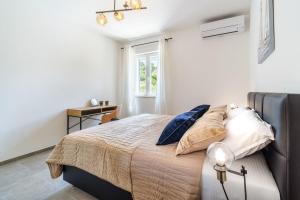 a bedroom with a bed and a window at House Villa Gold in Splitska +38 photos