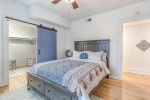 a bedroom with a bed and a blue door at Carson Flats Apt 3 - 1BR Near BOK, OSU Med, Dtwn in Tulsa
