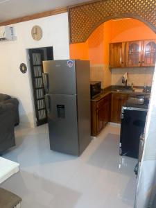 a kitchen with a stainless steel refrigerator in a room at New Kingston Gem in Kingston