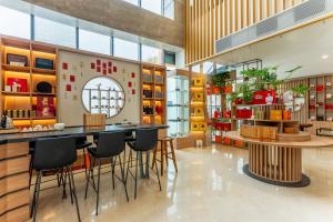 a restaurant with chairs and tables in a room at Holiday Inn Express Tianjin Airport East by IHG in Tianjin