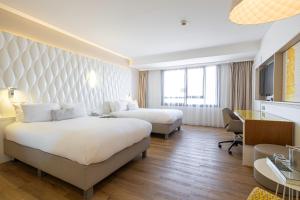 Postel nebo postele na pokoji v ubytování Renaissance Aix-en-Provence Hotel