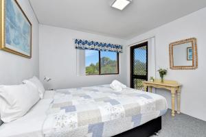 Ένα ή περισσότερα κρεβάτια σε δωμάτιο στο Foreshore Paradise Nelson Bay