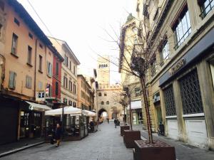 a city street with people walking down the street at Temporary House Oberdan in Bologna