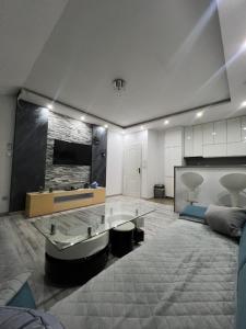a living room with a couch and a glass table at Apartman Stars in Brčko