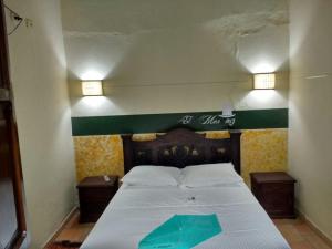 Ένα ή περισσότερα κρεβάτια σε δωμάτιο στο Hotel El Márquez