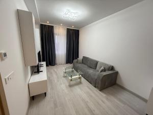 a living room with a couch and a table at Cataleya Suites Apartament's in Bucharest