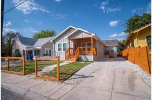 a house with a fence in front of it at Lovely Charming 4BR2.5BA Near Downtowns Prime in San Antonio