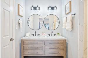 a bathroom with a sink and a mirror at Lovely Charming 4BR2.5BA Near Downtowns Prime in San Antonio +29 photos