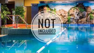 a swimming pool with a not included sign next to the water at Cataleya Suites Apartament's in Bucharest
