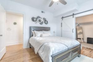 a white bedroom with a large bed with white sheets at Carson Flats Apt 6 - 1BR Near BOK, OSU Med, Dtwn in Tulsa