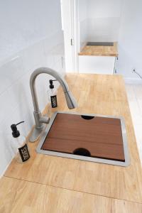 a kitchen sink with a faucet in a kitchen at Cozy apartment near Busch Gardens Adventure Island and USF in Tampa