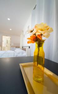 a vase filled with flowers sitting on a table at Cozy apartment near Busch Gardens Adventure Island and USF in Tampa