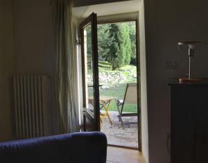 a living room with a door open to a patio at Haus Simoncini Alto in Gello