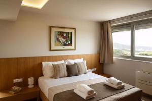 a bedroom with a bed with two towels on it at Diktamon Retreat Luxus Villa in Heraklion