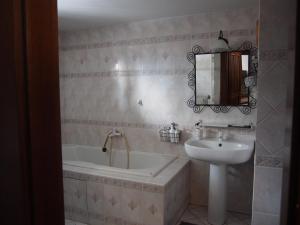 a bathroom with a sink and a bath tub and a sink at Chalúpka pod Lipkami in Kremnica