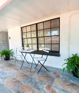 a patio with a table and chairs in front of a window at Cozy apartment near Busch Gardens Adventure Island and USF in Tampa