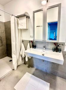a white bathroom with a sink and a shower at Cotton House in Novi Vinodolski +32 photos