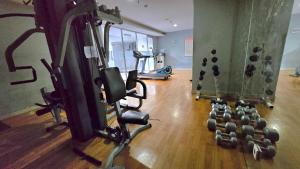 a gym with several treadmills and weights at BassuraCity Apartment near Hi-Speed Train Station -Min Stay 3 nights- in Jakarta