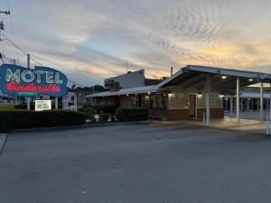 a motel with a sign in front of a building at Cinderella Motel in Hollister
