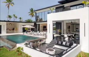 an exterior view of a house with a swimming pool at Casa B&W - Luxury Frente a Mar A 3 Minutos de la playa in Las Galeras