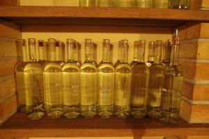 a bunch of glass bottles sitting on a shelf at Ubytování a apartmány Sluníčko in Lomnice nad Lužnicí